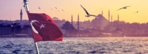 Turkish flag blowing in the wind with Istanbul mosques in the background