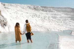 Mother and daughter walking in Pamukkale’s white thermal terraces