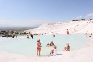 Visitors relaxing in the natural thermal terraces of Pamukkale during Turkey multi city tours