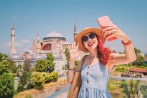 Young tourist taking a selfie with Hagia Sophia in Istanbul