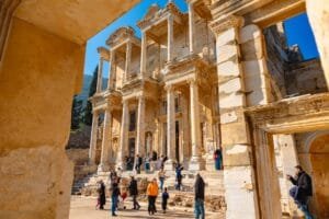 Tourists exploring the Library of Celsus in Ephesus, part of a multi city tour in Turkey