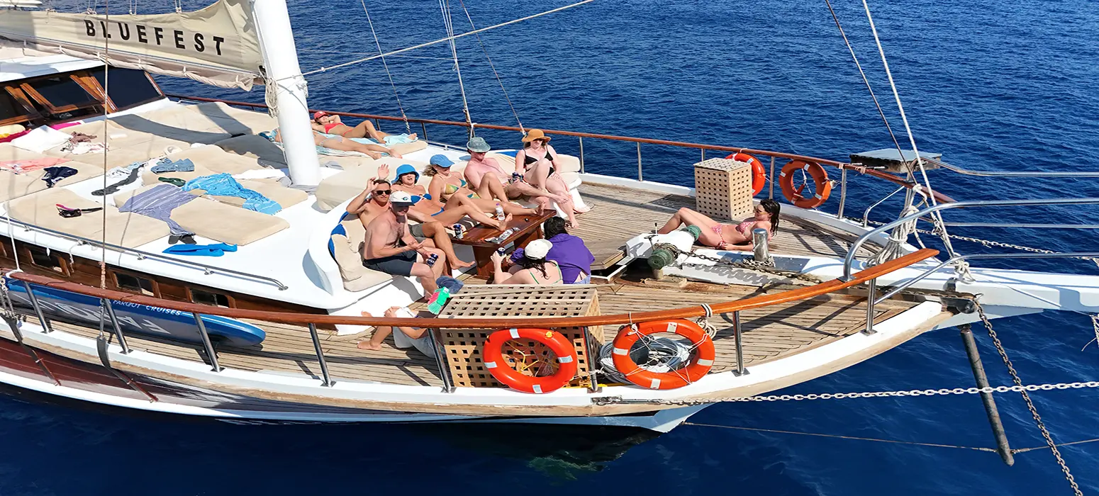 Travelers sunbathing and enjoying drinks on a Sail Turkey gulet deck