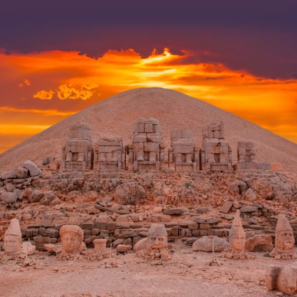 Sunset view behind ancient statues on Nemrut Mountain