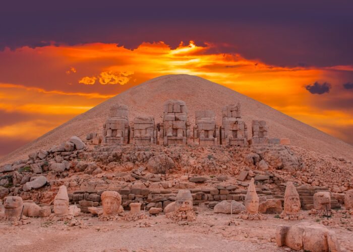 Sunset view behind ancient statues on Nemrut Mountain