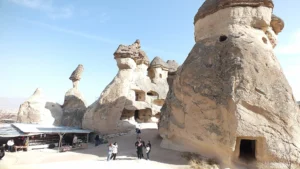 Visitors exploring Pasabag Valley fairy chimneys in Cappadocia