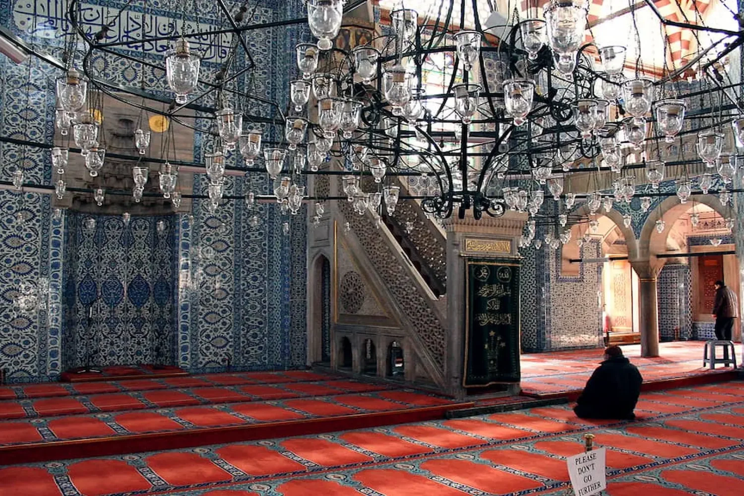 Prayer hall interior with chandeliers and Iznik tiles in Rustem Pasha Mosque Istanbul