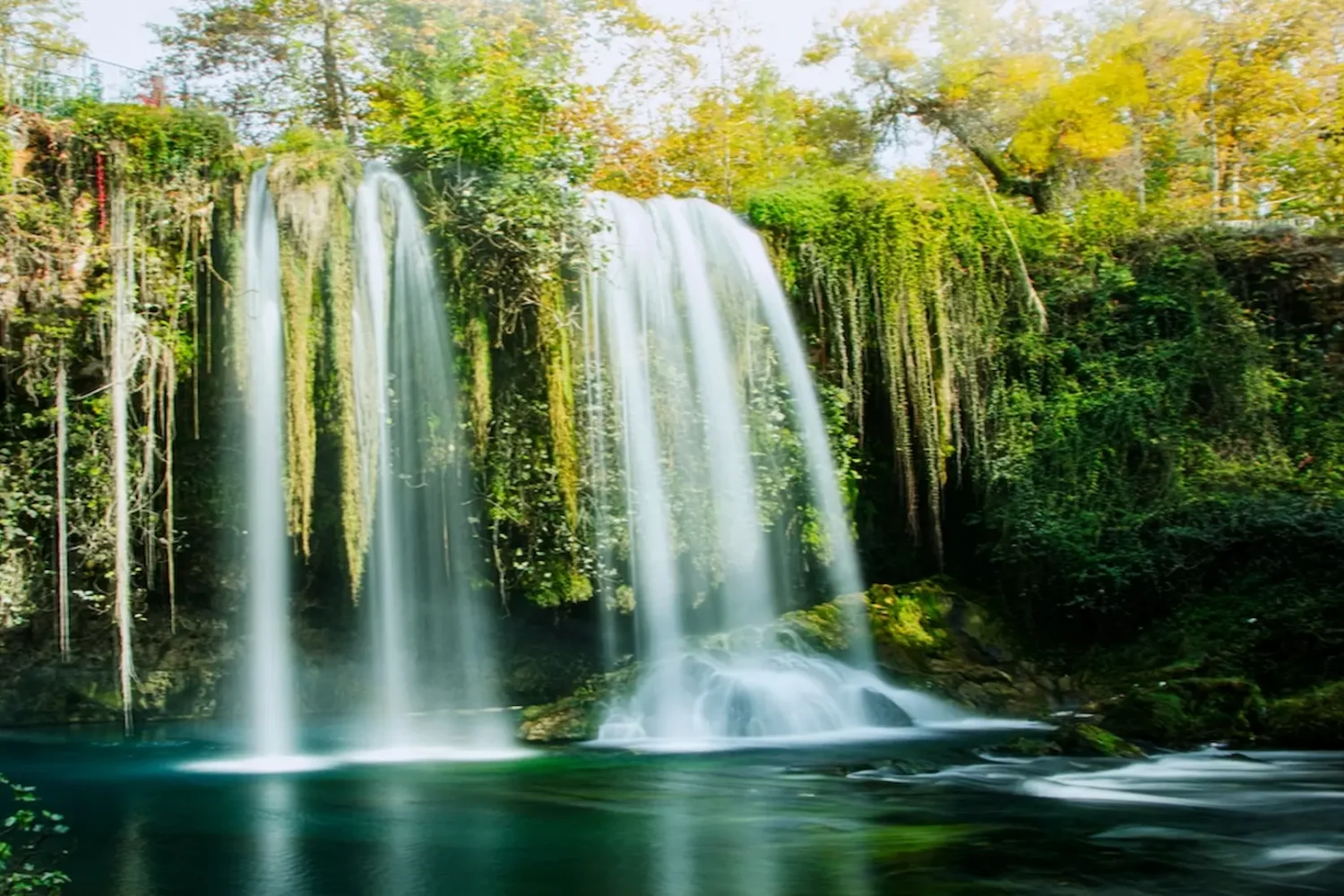 Scenic waterfall with green trees in Antalya