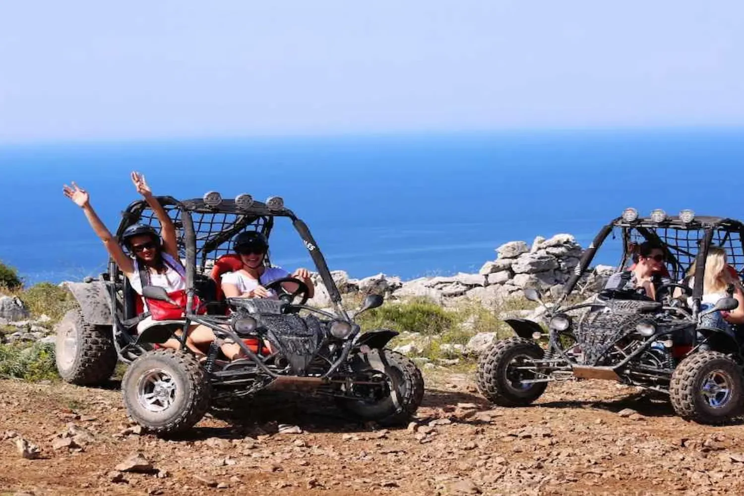 Tourists riding buggy cars with Mediterranean Sea view Antalya