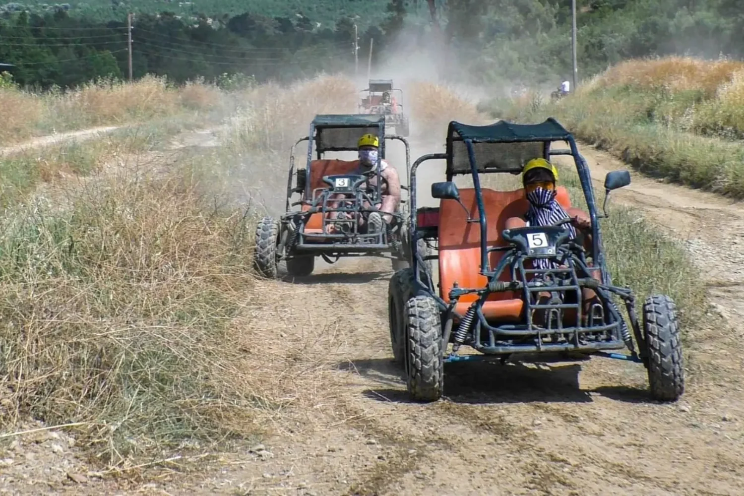 Tourists driving buggy cars on dusty off road trail Antalya