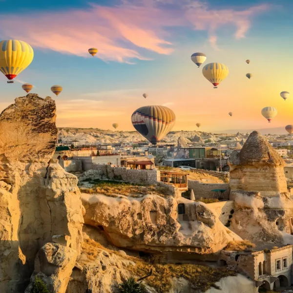 Sunrise view of Cappadocia with fairy chimneys and hot air balloons