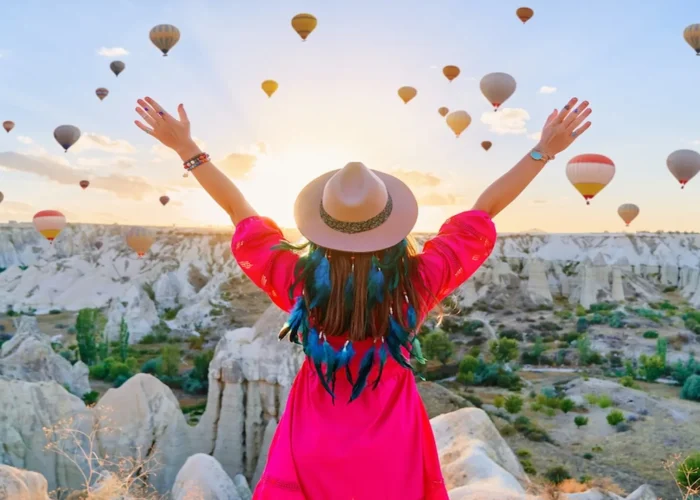 Traveler enjoying sunrise hot air balloons in Cappadocia