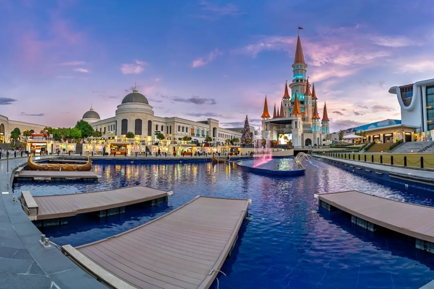 Illuminated fairy tale castle at Land of Legends Antalya in evening