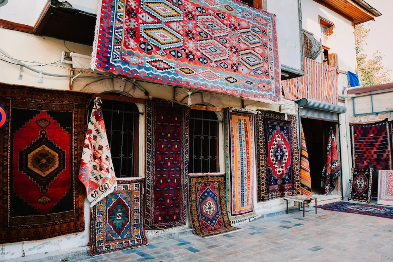 Colorful Turkish carpets hanging outside shop in Antalya Old Town