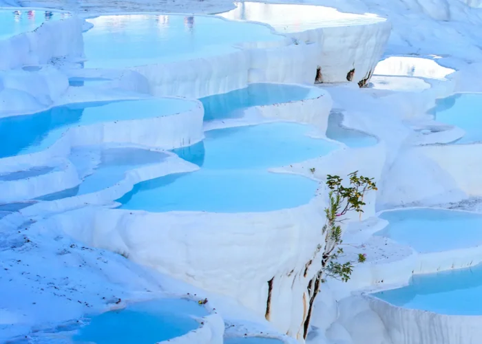 Natural blue pools on white travertine terraces in Pamukkale