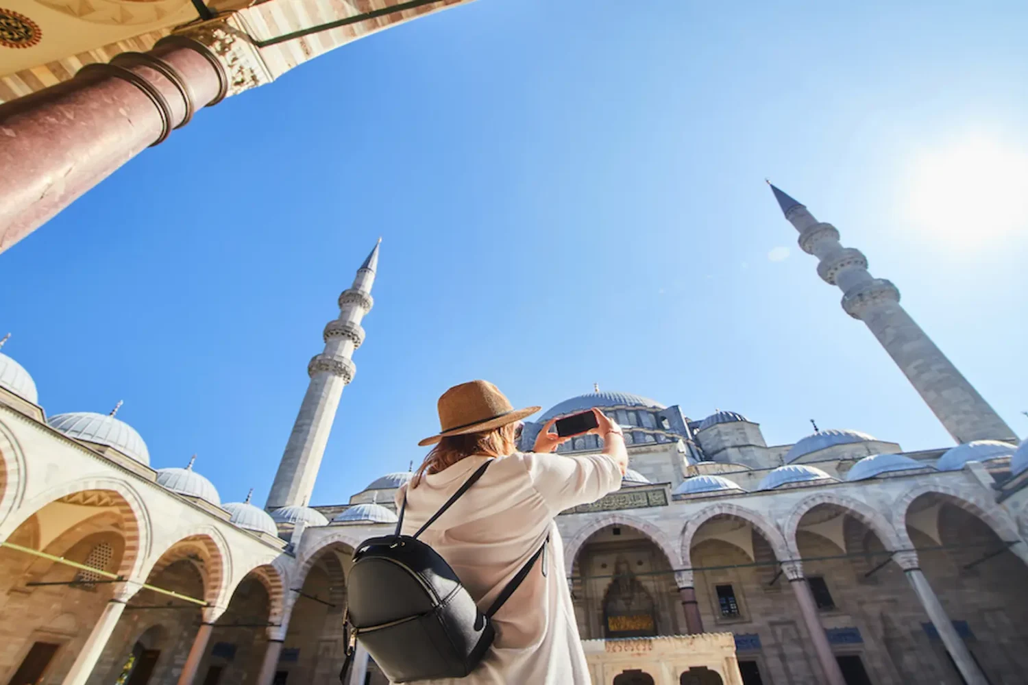 Traveler taking a photo of Suleymaniye Mosque courtyard in Istanbul