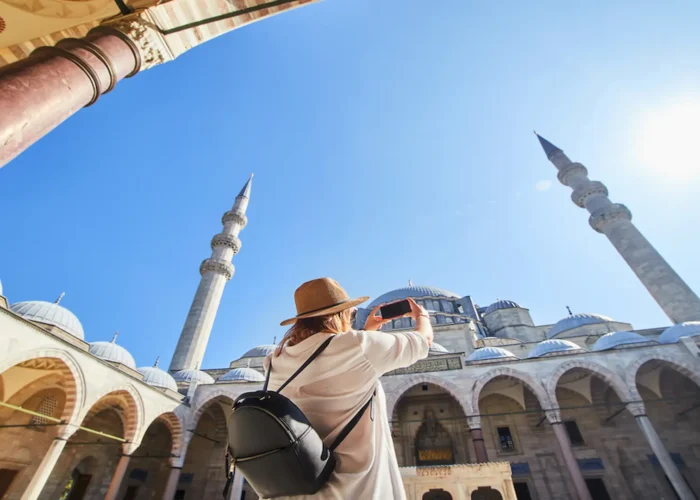 Traveler taking a photo of Suleymaniye Mosque courtyard in Istanbul