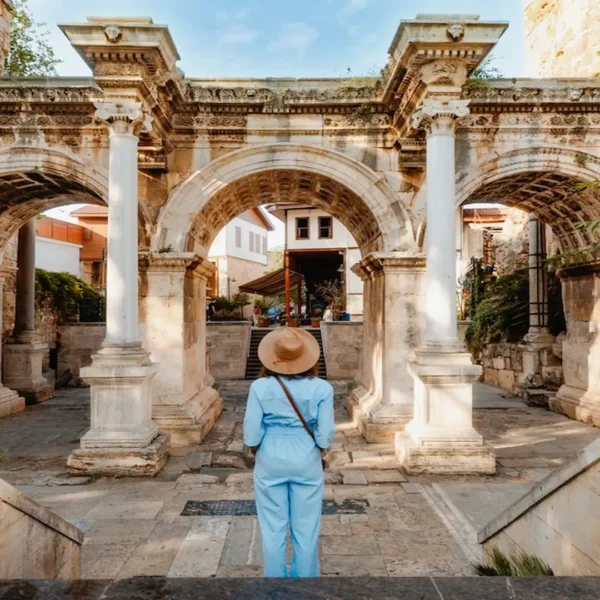 Visitor standing at Hadrian’s Gate in Antalya Old Town