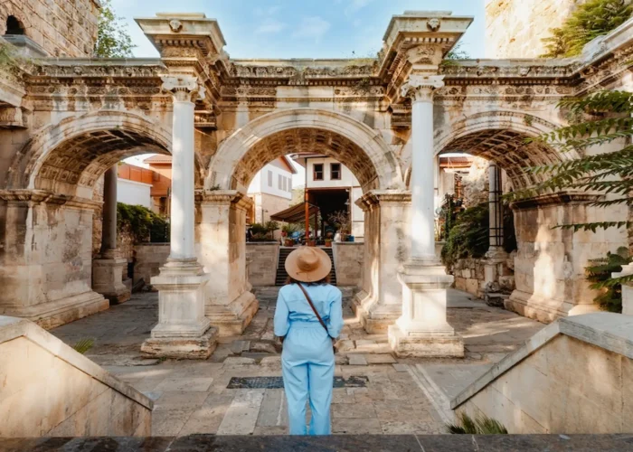 Visitor standing at Hadrian’s Gate in Antalya Old Town