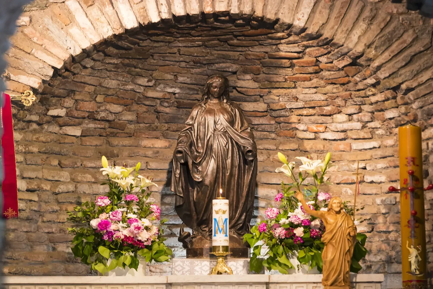 Virgin Mary shrine with flowers inside the house