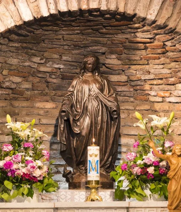 Virgin Mary shrine with flowers inside the house