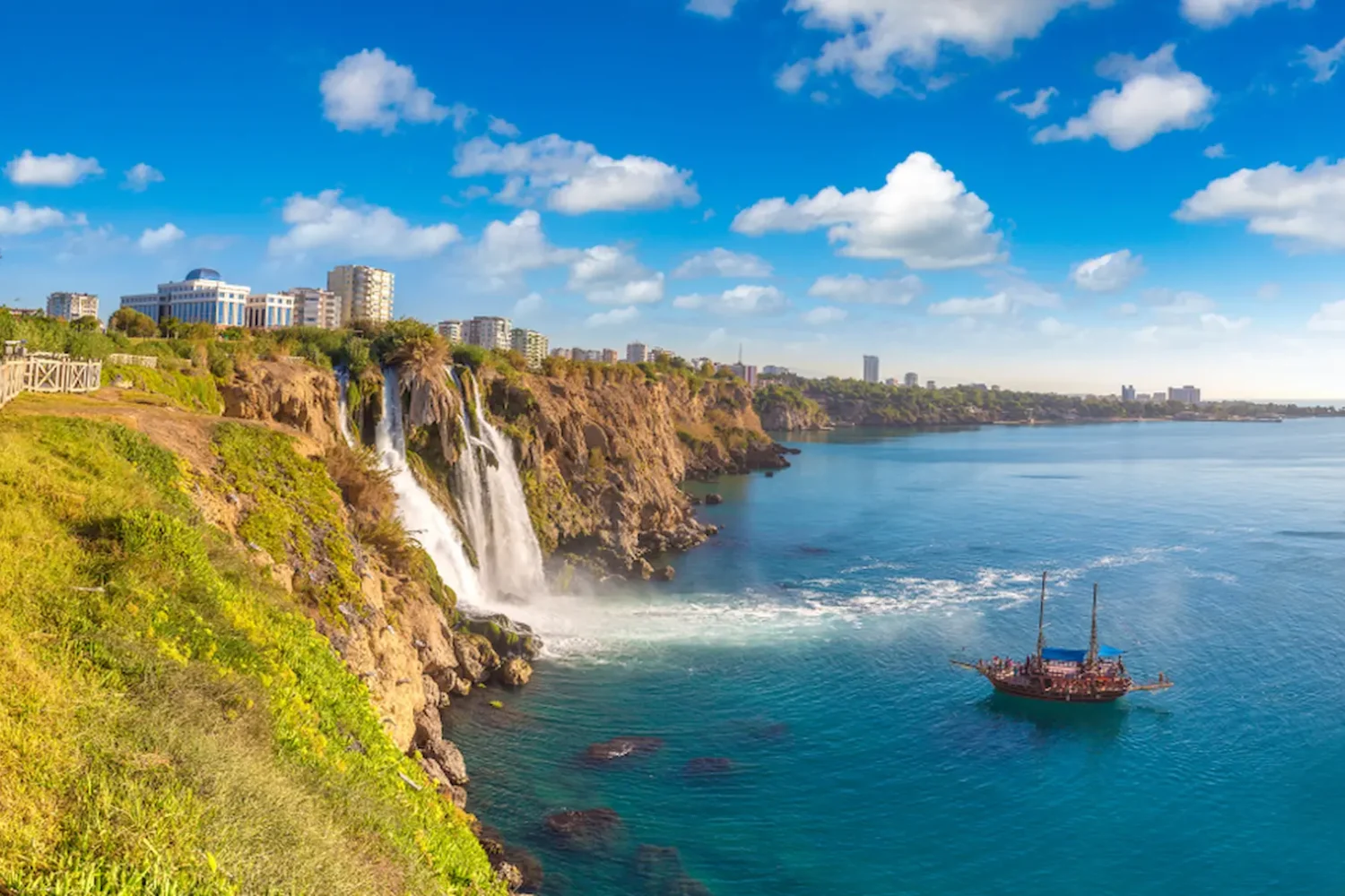 Lower Duden Waterfall flowing into the Mediterranean Sea with boat