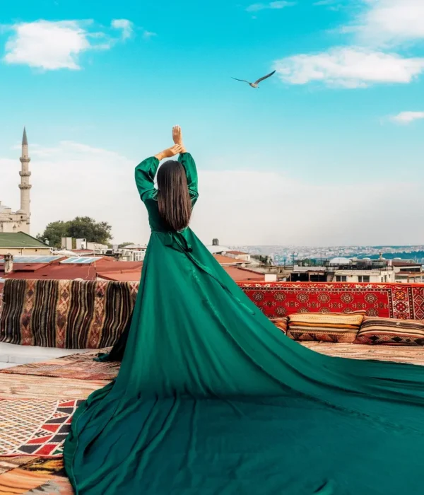 Woman in green dress overlooking Hagia Sophia and Istanbul rooftops