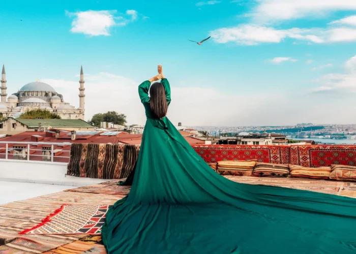 Woman in green dress overlooking Hagia Sophia and Istanbul rooftops