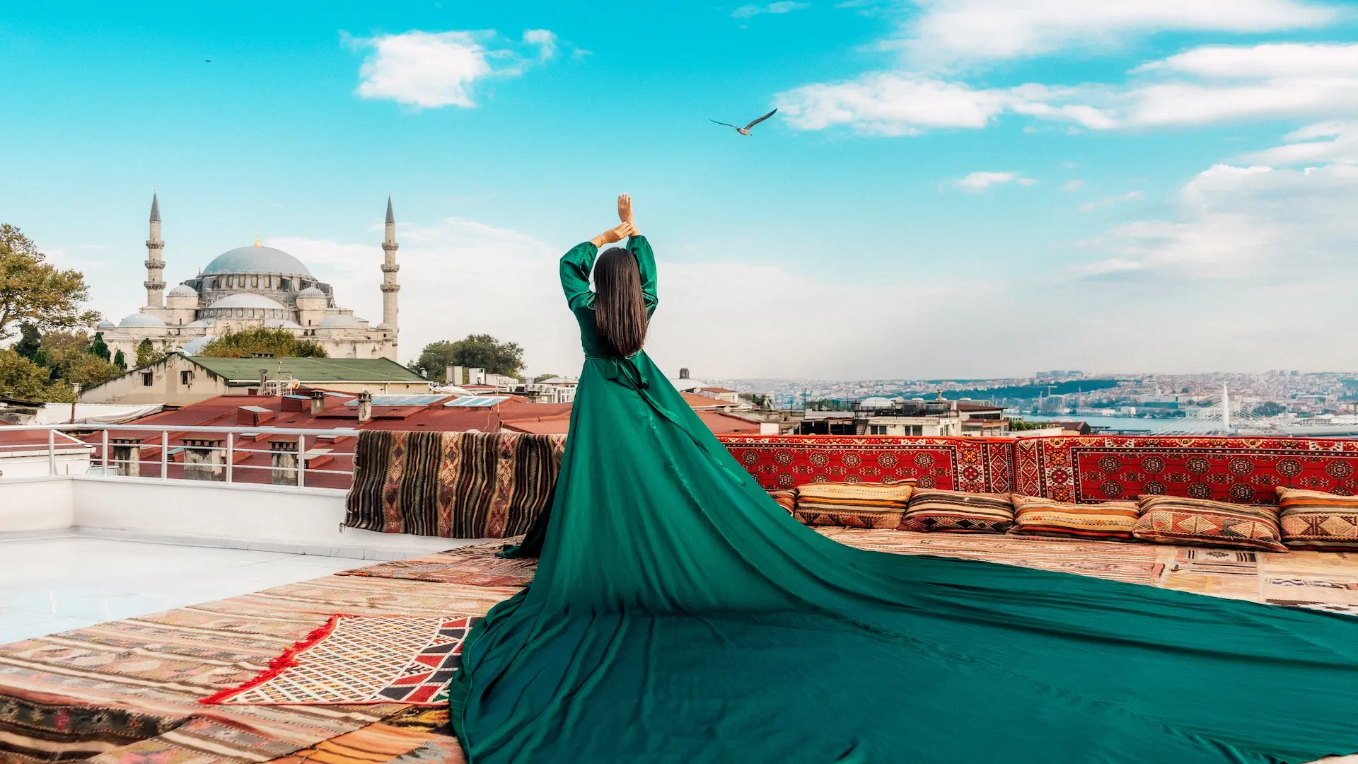 Woman in green dress overlooking Hagia Sophia and Istanbul rooftops