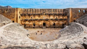 Interior view of Aspendos Ancient Theatre with stone seating and stage wall