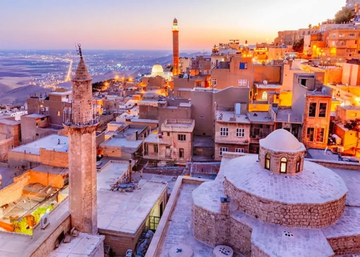 Sunset over stone rooftops and minarets in Mardin city
