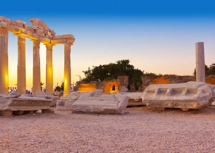 Illuminated Temple of Apollo ruins in Side at sunset on the Mediterranean coast