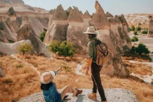 Traveler enjoying panoramic valley view in Cappadocia during a day tour