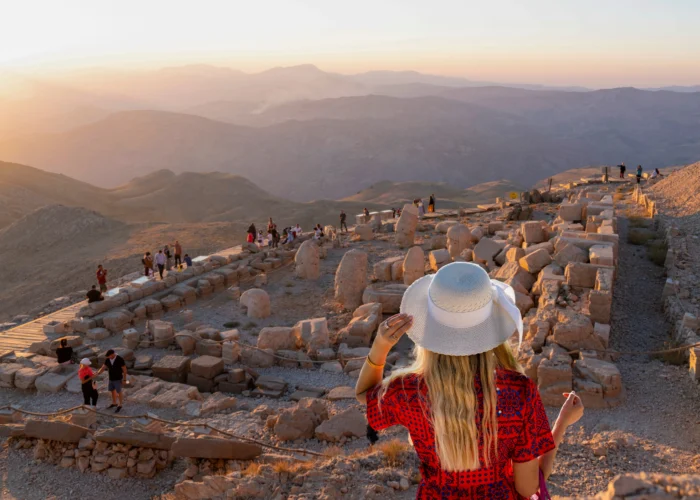 Tourists watching sunrise at Mount Nemrut archaeological site