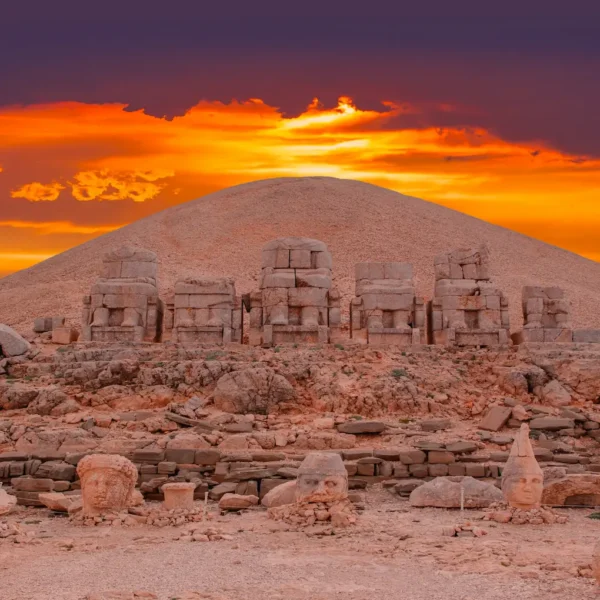 Sunset behind ancient statue heads on Nemrut Mount archaeological site